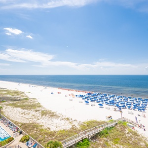 Breathtaking views of white sands and vibrant beach umbrellas create the perfect seaside escape