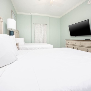 Sleep peacefully in this guest room, featuring plush queen beds and a large TV for your favorite shows at night