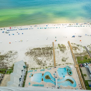 Discover the inviting pool area with gradual entry, a refreshing lazy river, and adventurous waterslide on the beach