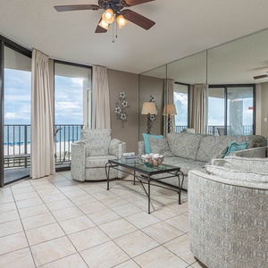 Unwind in the spacious living area featuring a queen sofa sleeper and beachfront view, perfect for relaxation