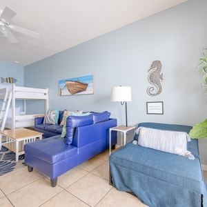 Unwind after a day at the beach in this cozy living area with a twin bunk bed