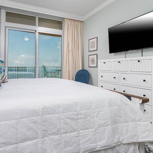 Rest on the plush king bed while streaming shows on the wall TV and watching the gulf through sliding glass doors