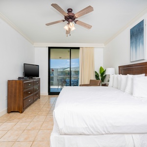 Drift into restful slumber in the king master suite, where cozy bedding and gentle breezes invite relaxation