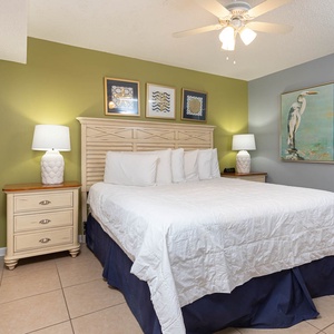 Unwind in the tranquil bedroom featuring a king bed, soft lighting, and coastal decor for a restful stay