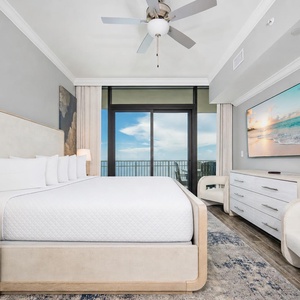 Unwind in the master suite featuring a king bed, stylish decor, and beachfront balcony access