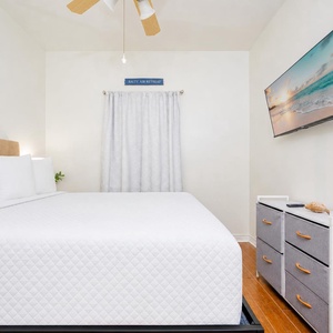 Rest in the guest suite where a gentle ceiling fan hums as you watch your favorite show on the wall TV