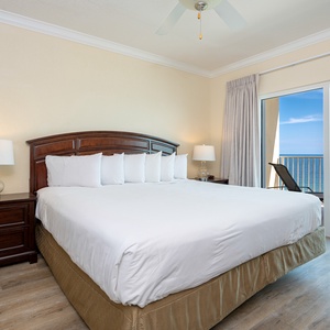 Master bedroom featuring a king bed and a stunning view from the balcony, perfect for relaxation