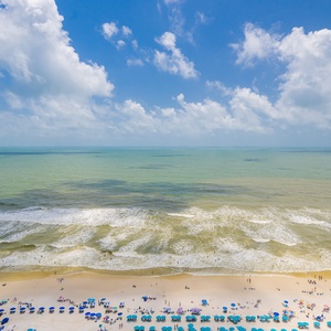 Stunning views of the coastline and clear blue waters from the spacious balcony, perfect for relaxation