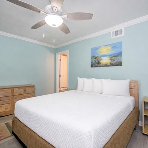 Drift into a restful night in this guest bedroom, where soft queen bedding invites relaxation and sweet dreams await