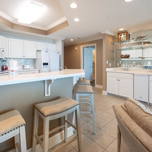 Enjoy casual dining at the breakfast bar, surrounded by a stylish kitchen with sleek cabinetry and white appliances