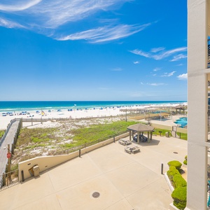 Relax on your balcony and watch families enjoy the beach and pool below