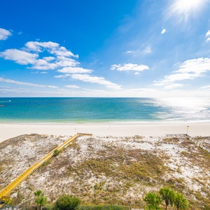Gaze at the serene waters and bright skies from your balcony, perfect for relaxation and enjoying the coastal scenery