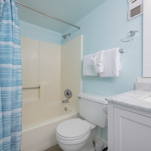 Feel rejuvenated in this master bath, with soft towels and marble accents enhancing your beach retreat experience