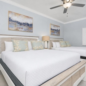 Experience restful nights in this inviting guest bedroom with two plush queen beds and calming decor