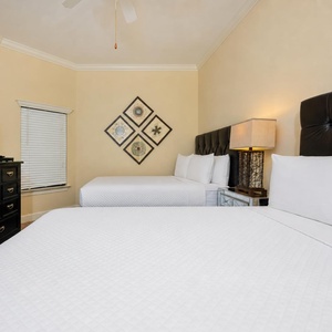 Experience restful nights in this inviting guest room, featuring queen beds and a cozy ambiance perfect for unwinding