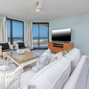 Unwind in the inviting living area, featuring comfortable seating and expansive views through large windows