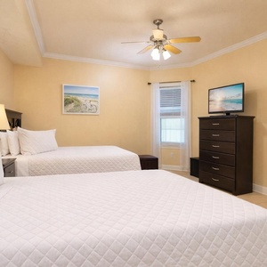 Drift into restful nights on plush double bedding in this guest bedroom, enjoying a cozy vibe and your favorite shows