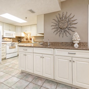 Bright kitchen invites you to prepare fresh beachside meals in this cozy kitchen