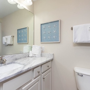 Freshen up in this guest bath in the relaxing shower or soothing tub before an exciting beach day