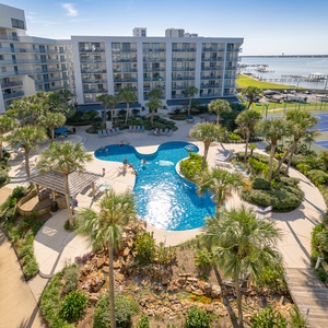 Gulf Shores Surf and Racquet club created a stylish oasis design surrounding the pool area, for a natural tropical vibe