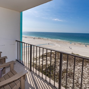 Savor the coastal views from your balcony while relaxing in comfortable chairs, perfect for unwinding after a day of