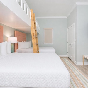 Cozy sleeping arrangement with two twin beds lofted above two queens, perfect for family fun