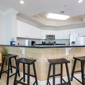 Enjoy morning coffee at the breakfast bar, feeling the inviting vibe of your beach getaway as the day begins