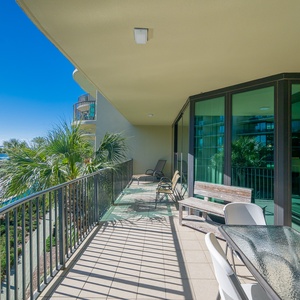 Breathe in the fresh air as you lounge on the spacious balcony, surrounded by pool and bay views