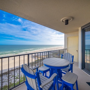 Blue skies stretch over the gulf as you relax around your balcony table watching waves roll onto the shore
