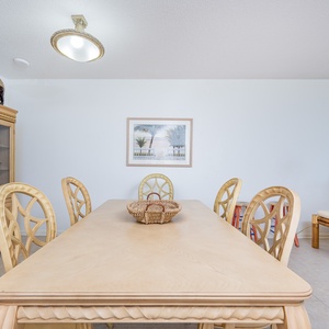 Gather around the spacious dining table, perfect for meals and enjoying the coastal decor that enhances your stay