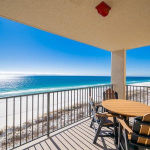 Savor meals at the outdoor table while enjoying breathtaking views of the sparkling waters and coastline