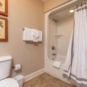 Freshen up in this guest bath in the relaxing shower or soothing tub before an exciting beach day