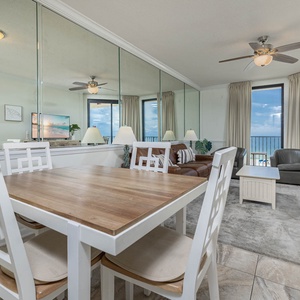 Gather around the dining table for meals while enjoying the inviting atmosphere and beach views through large windows