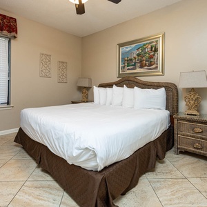 Unwind in the inviting bedroom featuring a plush king bed, stylish decor, and a mounted TV for your entertainment