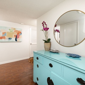 Step into a vibrant entryway where personal decor welcomes you, setting the tone for a relaxing beach getaway