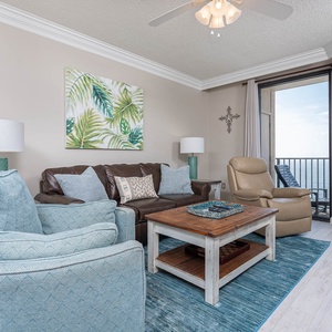 Relax in the inviting living area with a sofa with queen sleeper, a rustic coffee table, and beachfront views