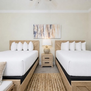 Rest comfortably in this queen suite surrounded by fluffy pillows and a relaxing coastal vibe