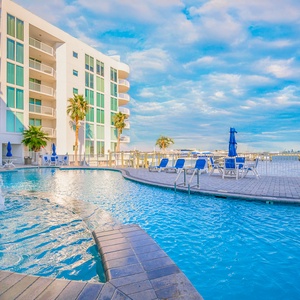 Take a dip in the refreshing outdoor pool and cool off under the sun with breathtaking views at The Pass in Orange Beach