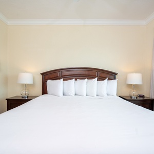 Cozy master bedroom featuring a plush king bed, soft linens, and warm lighting for a cozy atmosphere