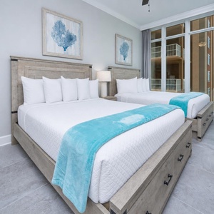 Settle into the two queen beds, step to the glass windows, and admire the coastal surroundings