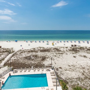 Relax with beachfront views from this inviting space, complete with a sparkling pool and relaxing lounge area
