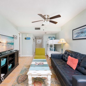 Inviting living area featuring a cozy couch, TV, and a playful bunk bed for family fun