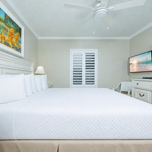 Serene guest bedroom featuring a king bed, soft linens, and coastal art for a restful night's sleep
