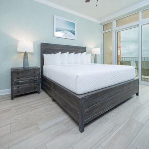 Retreat to the king master suite with cozy bedding and drift off to the sound of the waves from the balcony