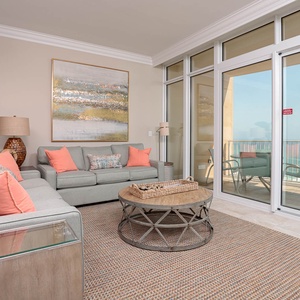 Relax in the inviting living area, enjoying the coastal breeze and views right from the sofas, featuring a queen sleeper