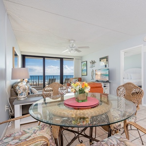 Savor the cozy vibes as you share laughter and stories around the glass dining table with stunning coastal views