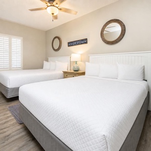 Unwind in this queen guest suite, where plush bedding and nautical decor create a restful retreat for your family
