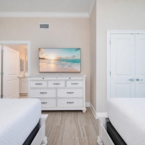 Relax in this guest room with two queen beds, a large TV, and adjoining guest bathroom