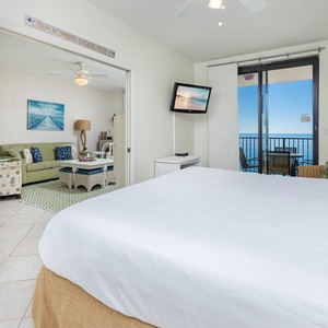 Experience comfort in the master bedroom with a king bed, leading to the beachfront balcony and living space