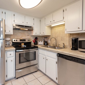 This kitchen features stainless appliances, ample cabinetry, and a welcoming atmosphere for preparing meals together